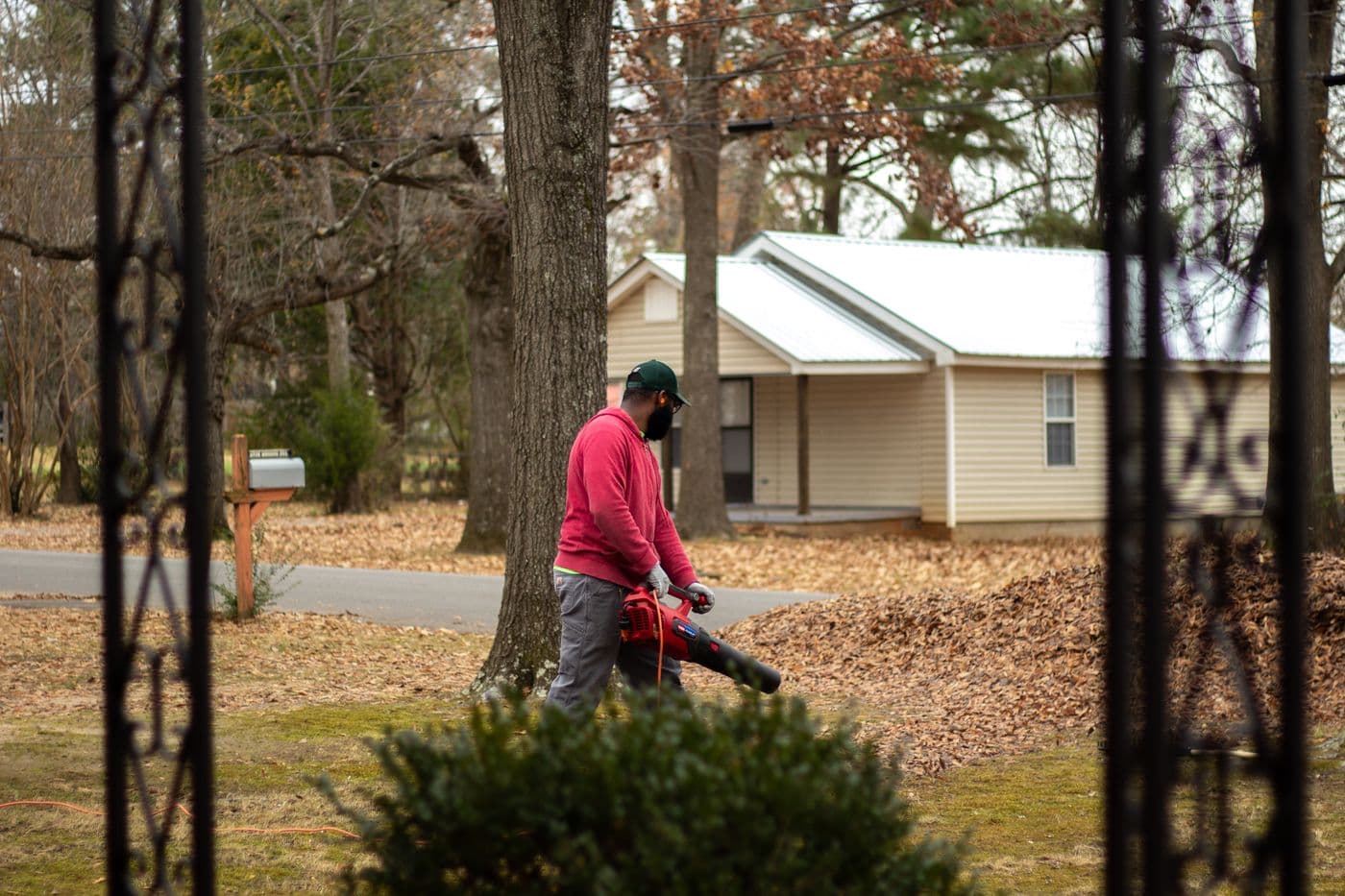 Crew clearing leaves and debris from a residential property