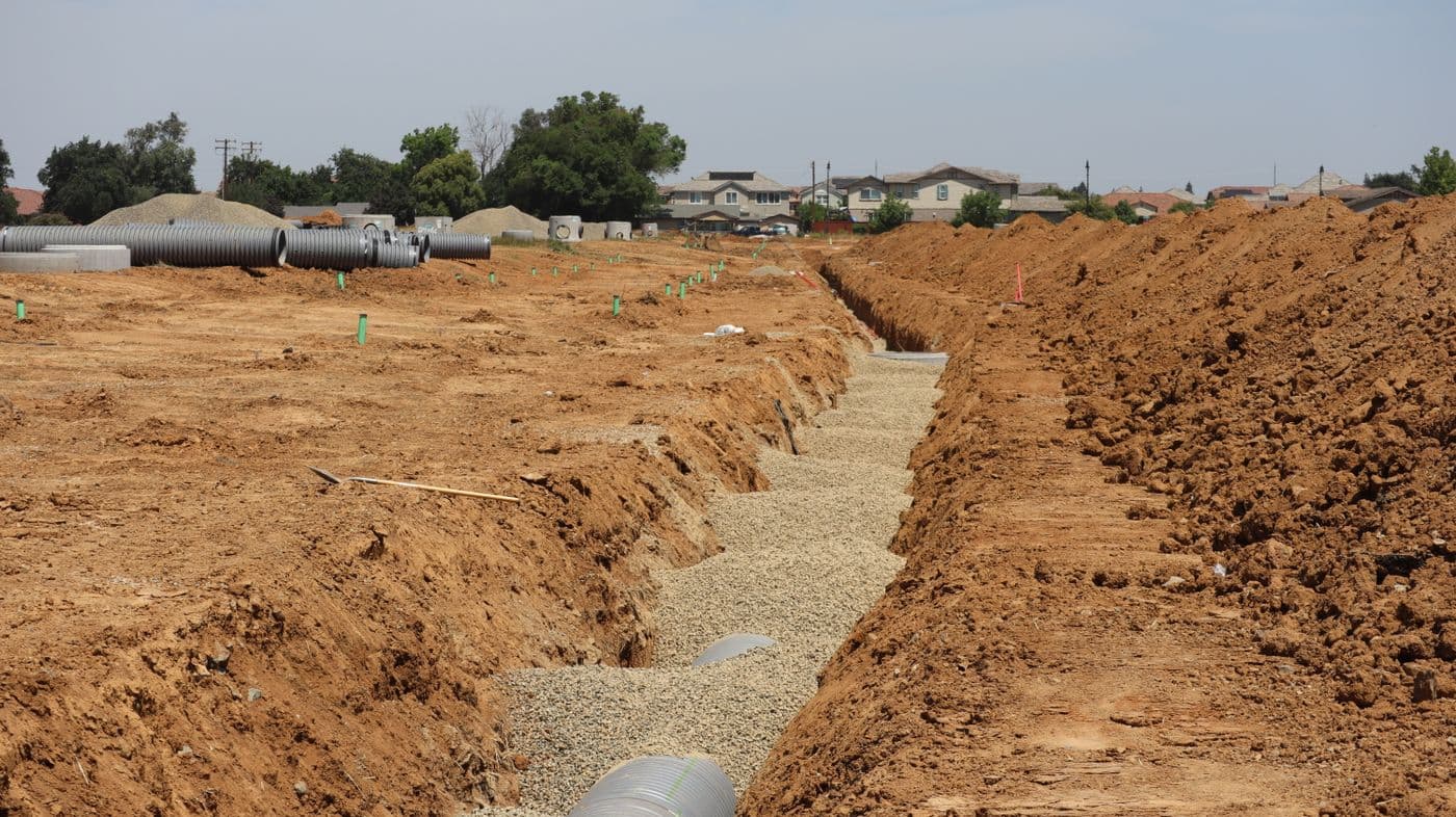 Drainage trench and pipe installation in a residential yard